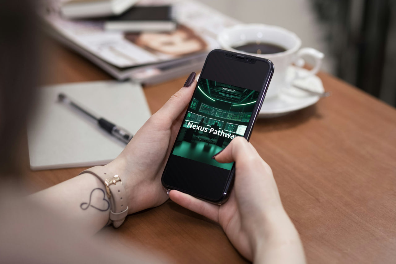 Person holding a smartphone with aQuantum System app on a wooden table with a coffee cup and magazine in the background.